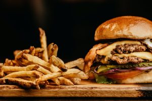 Burger and Fries on Wooden Board