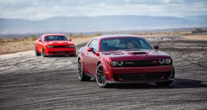 Two Red 2021 Dodge Challengers Driving on Road