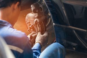 Service Technician Repairing Brakes
