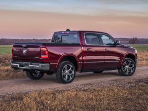 Red 2024 Ram 1500 driving on dirt road